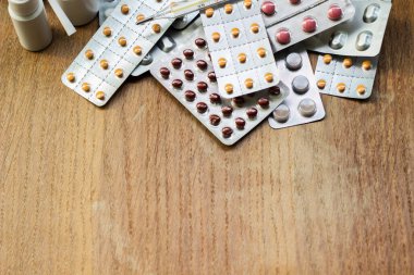 Ahşap zemin üzerinde çeşitli kapsüller, haplar ve kabarcıklar geniş bir grup arka plan