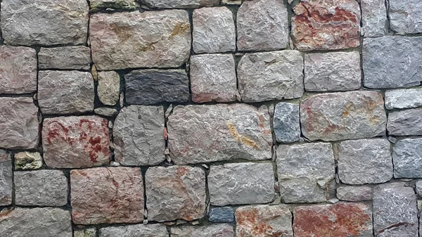 Taş bir duvarın dokusu. Köy taşı duvar dokusu arka planı.