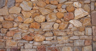 Eski bir taş duvar arka planı. Tamir edilmiş taş bir duvar. Kapat..