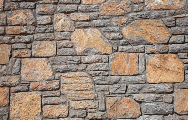 Kamienne Tło Kamiennej Ścianie Umieszczono Pomarańczowe Szare Kamienie Zamknij Się — Zdjęcie stockowe