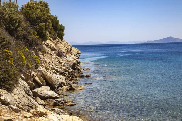Sea view and rocky beach with blue sky. Landscape. Mediterranean coast on a sunny day. Holiday concept.