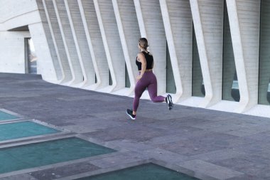 woman running in the city with mirrors