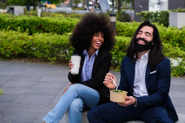 Two coworkers taking a break and enjoying themselves