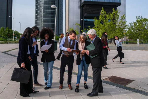 Group of financial district workers working outdoors together