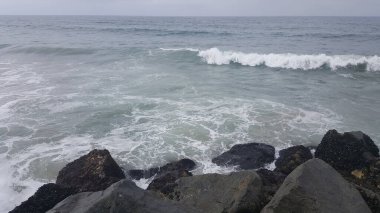 California shore - beautiful waves splashing against the rocks