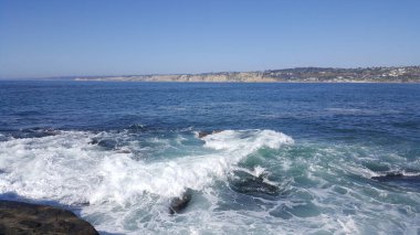 California shore - beautiful and powerful waves splashing against the rocks