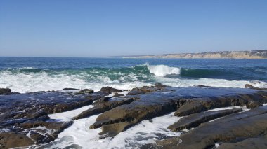 California shore - beautiful and powerful waves splashing against the rocks