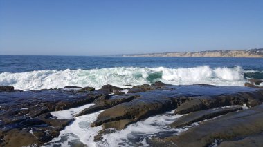 California shore - beautiful and powerful waves splashing against the rocks