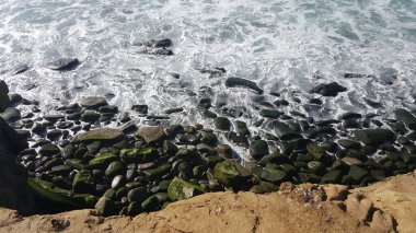 California shore - beautiful waves splashing against the rocks
