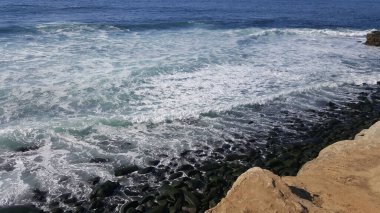 California shore - beautiful waves splashing against the rocks