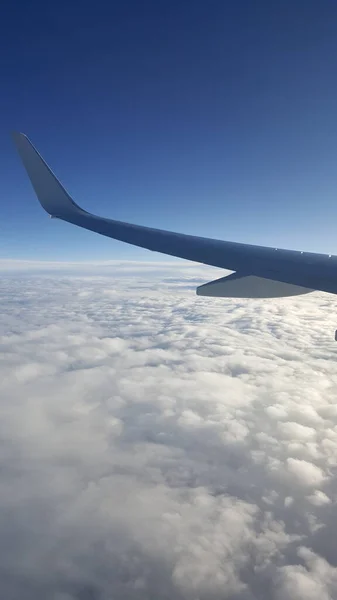 Flying high above beautiful fluffy clouds