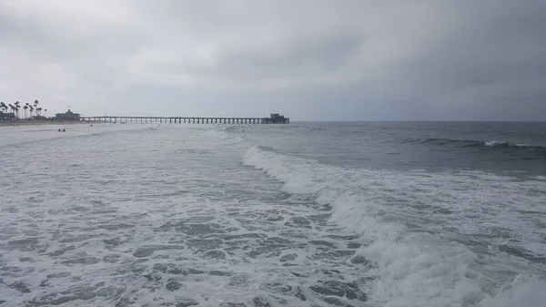 California shore - beautiful waves splashing against sandy shore