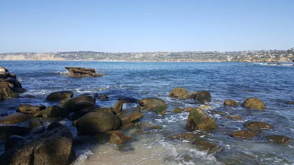 California shore - beautiful waves splashing against the rocks