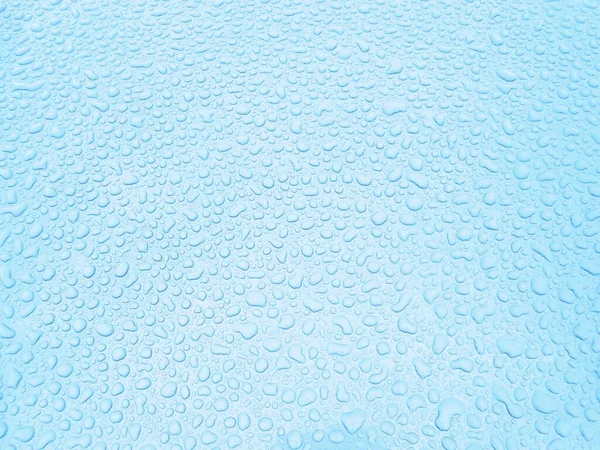 water drops on light blue glass