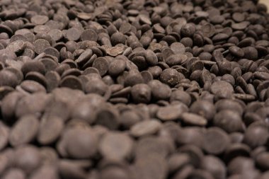 Field of many dark brown chocolat pellets
