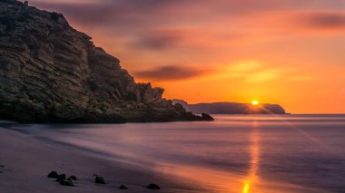 Sun rises over figueira beach at morning