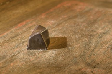 Dark chocolate praline on brown wooden table