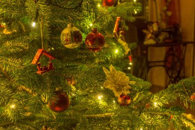 Detail of christmas decoration on green christmas tree