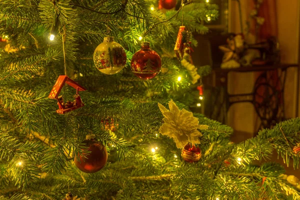 Detail of christmas decoration on green christmas tree