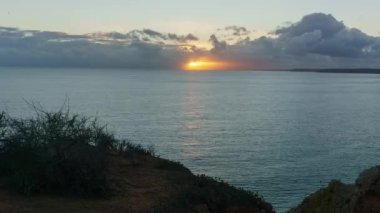 Gün batımının zamanı denizin üzerindeki bulutlu gökyüzünde, Lagos, Algarve, Portekiz
