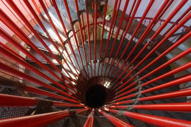 Kulede kırmızı boruları olan sarmal çelik merdiven.