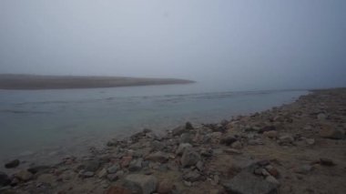 Strong stream of tidal flow on a foggy morning in Bretagne, France