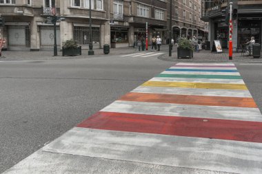 Crosswalk painted in rainbow color flag on street in Brussels, Belgium