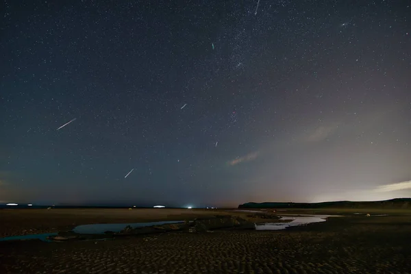 Shooting stars of perseids over north sea beach with german World War 1 submarine wreck SM UC 61, Wissant, Calais, France