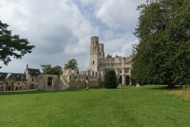 Ruin of the monastery with the Abbey Jumieges with green meadow in front, Normandy, France