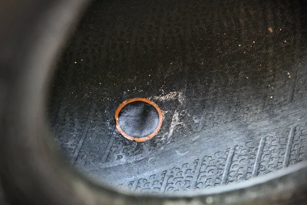 Close up of a patch inside a riding mower tire to repair a puncture.