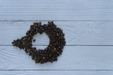 Coffee beans isolated circle inside on white wooden background