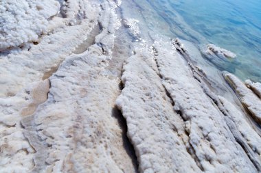 Dead sea beach, of Jordan. Decreasing every year, it is famous for its saturated salty waters; the water is so salty that no marine life can survive in this sea, and so dense that you can swim on the surface of the water and not dive deep.