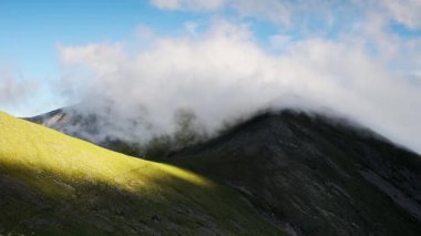 Clouds rolling on over the mountains