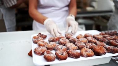 Preparation of sugar donuts, sprinkled with sugar, aniseed (Traditional dessert Brunyols in Catalonia, Spain)