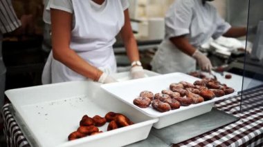 Preparation of sugar donuts, sprinkled with sugar, aniseed (Traditional dessert Brunyols in Catalonia, Spain)