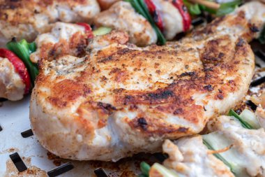 Tavuk göğsü ve domuz eti taze renkli ve lezzetli sebzelerle ahşap şişte çekiliyor.