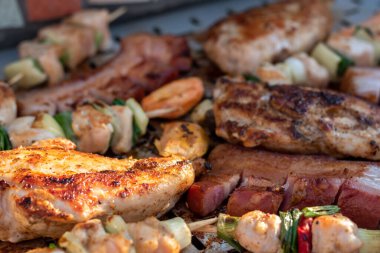 Tavuk göğsü ve domuz eti taze renkli ve lezzetli sebzelerle ahşap şişte çekiliyor.