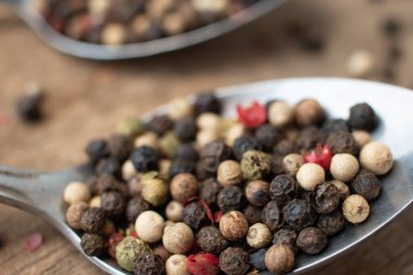 Various colored pepercorns on a dark background