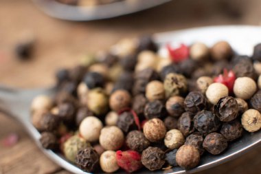 Various colored pepercorns on a dark background