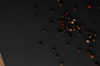 Various colored pepercorns on a dark background