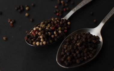 Various colored pepercorns on a dark background