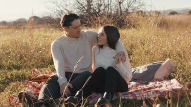 Couple in a field On The Meadow at sunset