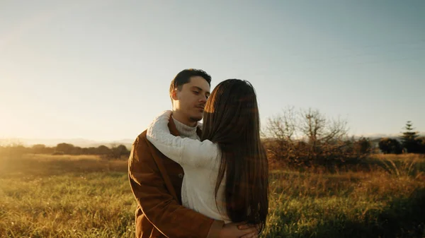 Romantik çift gün batımında dışarıda kucaklaşıyor. — Stok fotoğraf