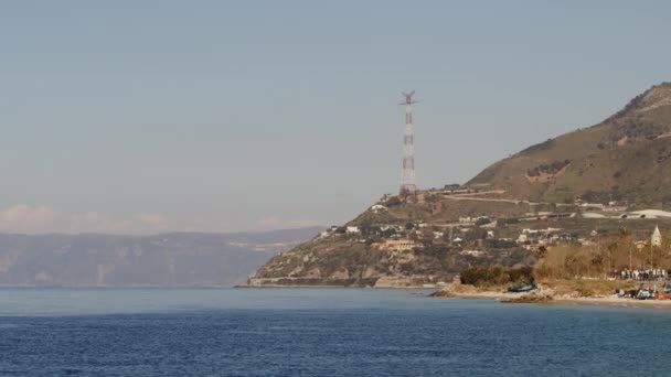 Electricity pylon on coastline long shot — Vídeo de stock