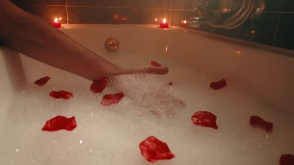 Hand touches foam in bathtub — Video