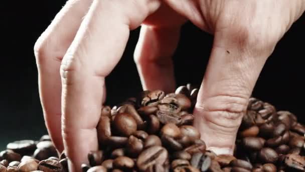 Hand touching roasted coffee beans — Stockvideo