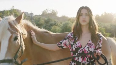 Girl with curious brown horse. 