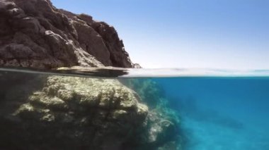 Half underwater of a sea cliff.