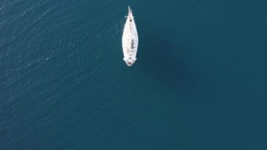 Aerial view of moored sailboat in the ocean 