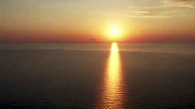 Aerial view of Stunning sunrise over calm ocean 